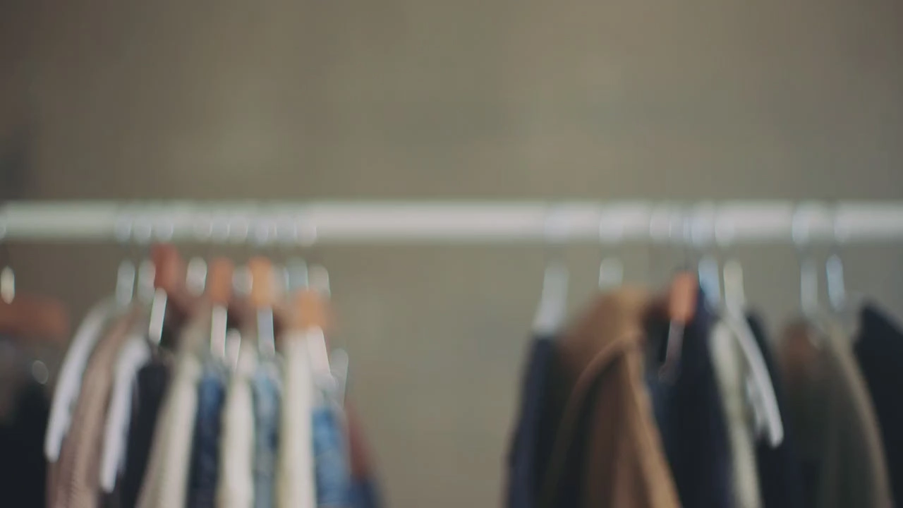 A rack of hanging jackets and denim in soft focus